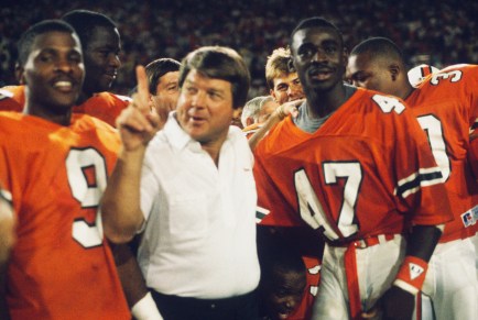MIAMI - NOVEMBER 28: University of Miami Hurricanes head coach Jimmy Johnson celebrates with Michael Irvin #47 following the game against the Notre Dame Fighting Irish at the Orange Bowl on November 28, 1987 in Miami, Florida. Miami defeated Notre Dame 24-0. (Photo by Focus on Sport/Getty Images)