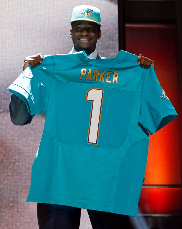 Louisville wide receiver Devante Parker poses for photos after being selected by the Miami Dolphins as the 14th pick in the first round of the 2015 NFL Draft,  Thursday, April 30, 2015, in Chicago. (AP Photo/Charles Rex Arbogast)