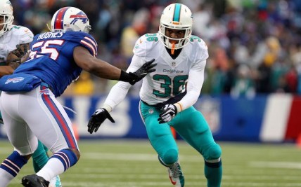 Dec 22, 2013; Orchard Park, NY, USA; Buffalo Bills outside linebacker Jerry Hughes (55) looks to block Miami Dolphins strong safety Don Jones (36) at Ralph Wilson Stadium. Mandatory Credit: Timothy T. Ludwig-USA TODAY Sports