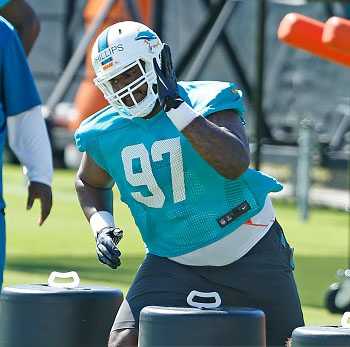 DAVIE, FL - MAY 8: Jordan Phillips #97 of the Miami Dolphins runs drills during the rookie minicamp on May 8, 2015 at the Miami Dolphins training facility in Davie, Florida. Phillips was the Dolphins second round draft pick. (Photo by Joel Auerbach/Getty Images) *** Local Caption *** Jordan Phillips