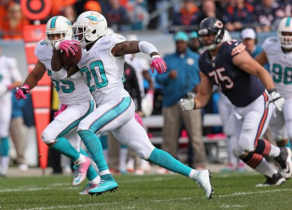 CHICAGO, IL - OCTOBER 19:  Reshad Jones #20 of the Miami Dolphins runs with ball during the second quarter of a game against the Chicago Bears at Soldier Field on October 19, 2014 in Chicago, Illinois.  (Photo by Jonathan Daniel/Getty Images)