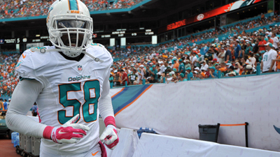 Oct 12, 2014; Miami Gardens, FL, USA; Miami Dolphins linebacker Chris McCain (58) runs during the second half against the Miami Dolphins at Sun Life Stadium. The Packers won 27-24. Mandatory Credit: Steve Mitchell-USA TODAY Sports